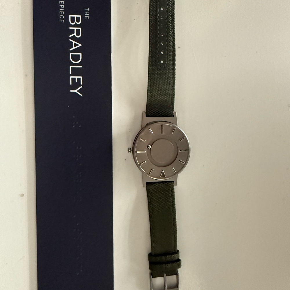 Unique watch with magnetic ball bearing time telling features.